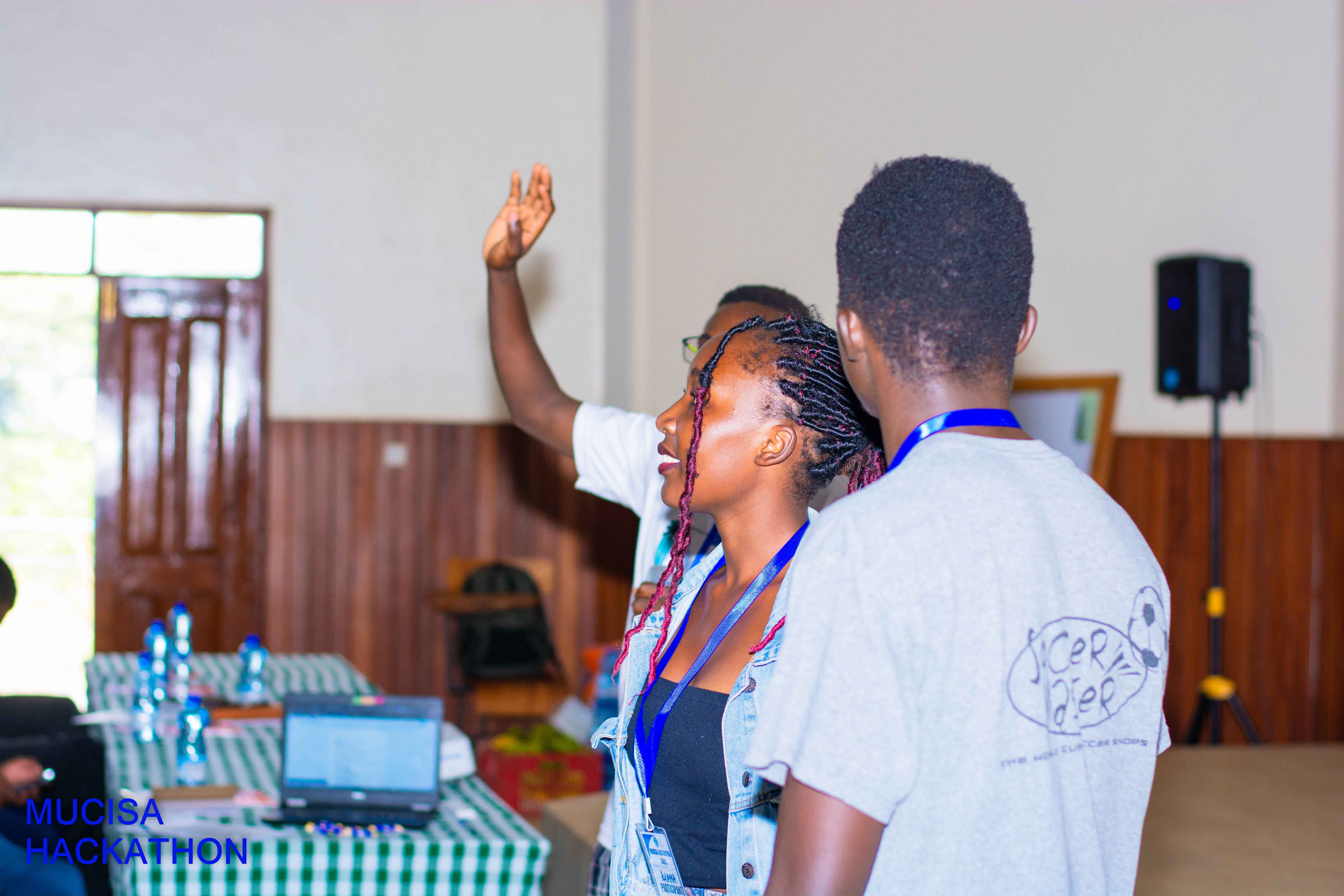 Students collaborating with a mentor at the hackathon