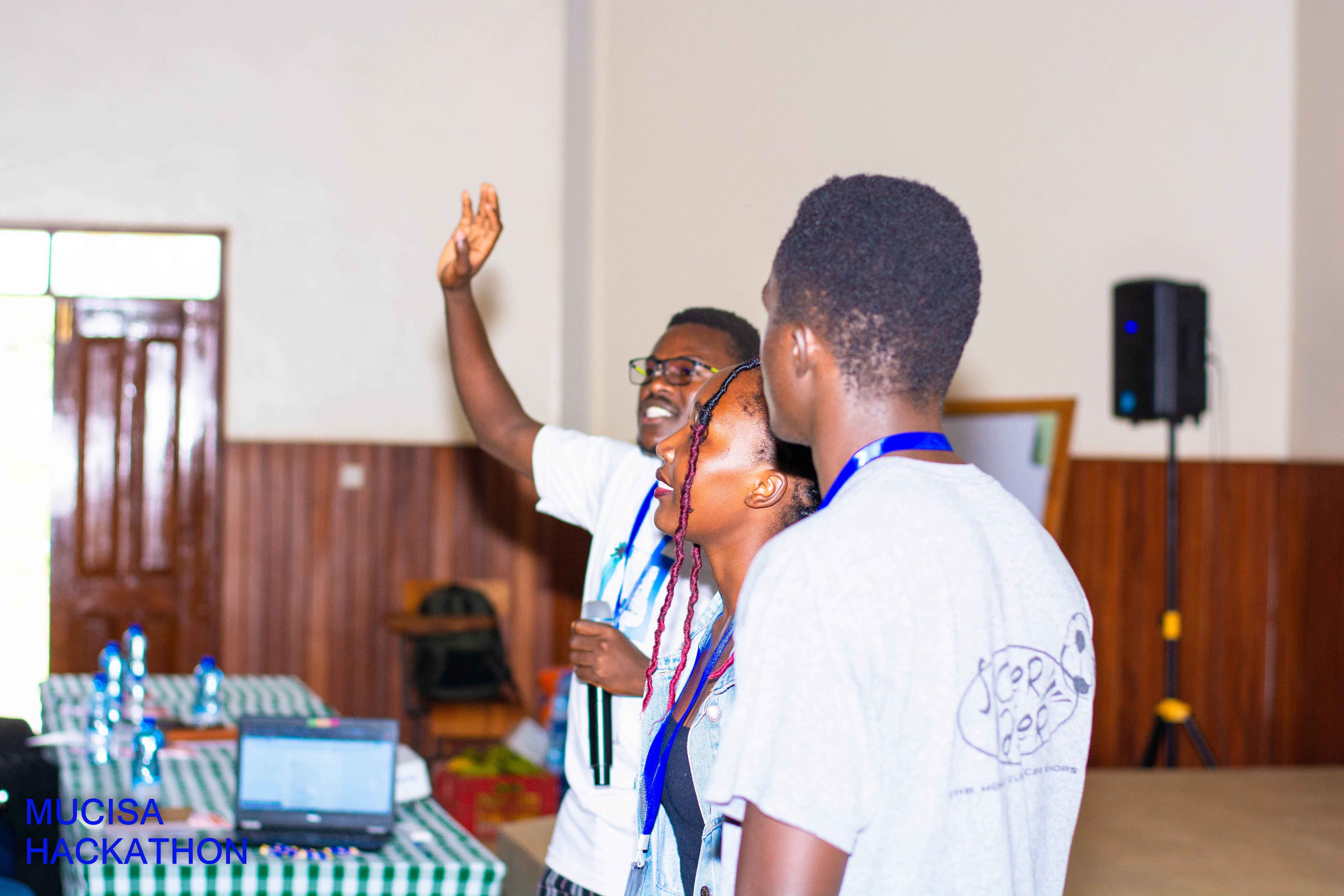 Mentor explaining concept to students at hackathon